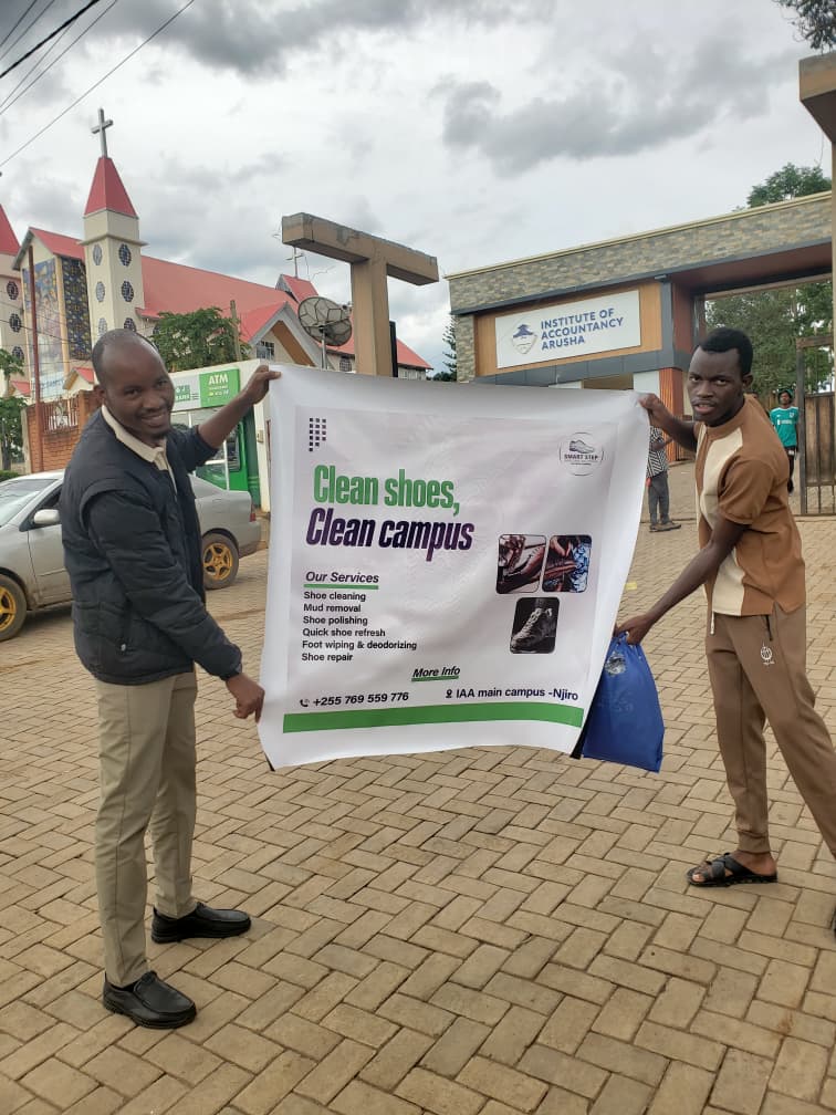Smart Step Clean Shoes Clean Campus campaign outdoor banner at Institute of Accountancy Arusha (IAA) by G DESIGN